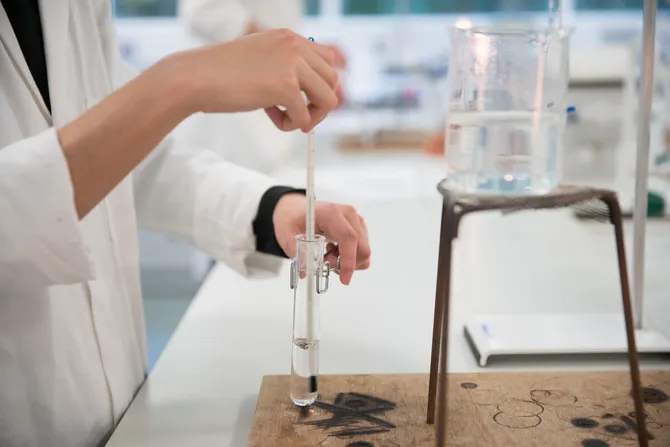 student in chemistry lab using equipment
