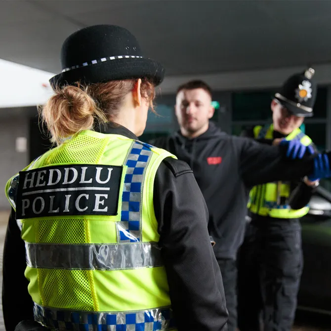 Two policing students simulating an arrest during a practical assessment