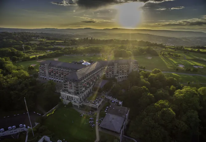 aerial shot of the celtic manor resort at sunset