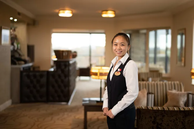 Esther Zee Wong hospitality and management student standing in celtic manor restaurant