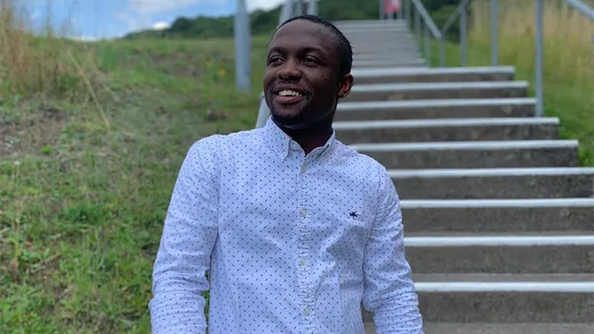 law student standing on steps looking off past the camera