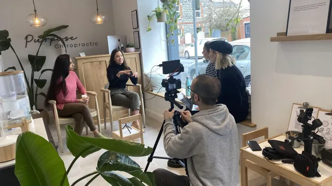 Members of the Alumni team interviewing two USW graduates at their workplace