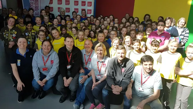 Caerleon brownies smile for a photo with the cyber security team during a visit to Newport campus