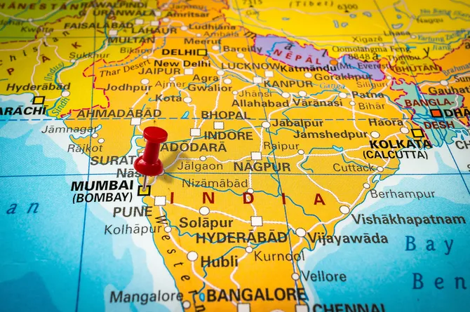 Map of the world with a red pin placed on Mumbai