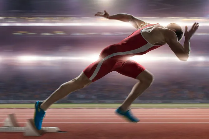 Close up image of a professional male sprinter mid race