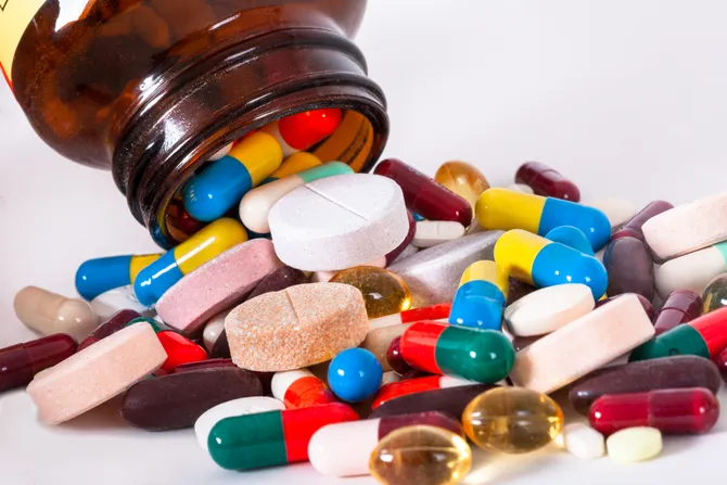 A variety of different pills spilled out on to a table