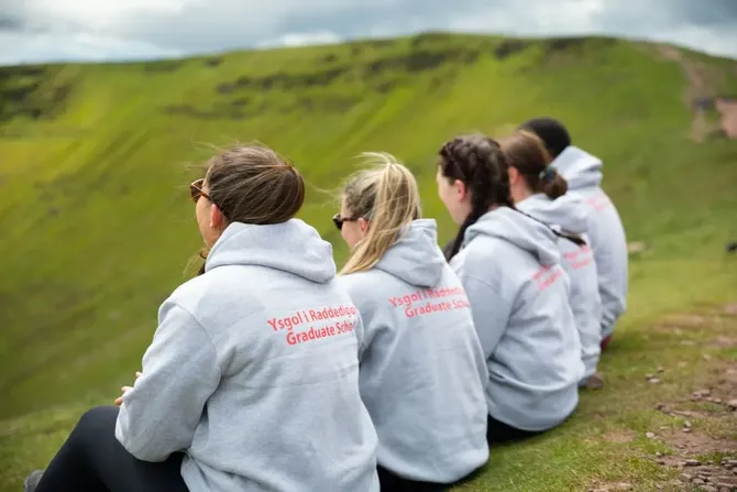 Three Postgraduate researchers students on a trip to Pen-Y-Fan