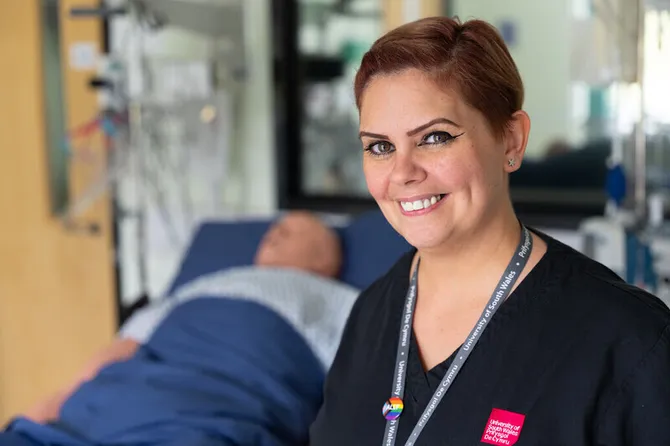 Lecturer, Tamara Edwards, stood in the nursing simulation centre in front of a mannequin in a hospital bed.
