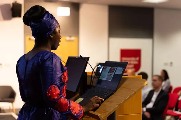 key speaker at postgraduate research annual presentation speaking to audience from podium
