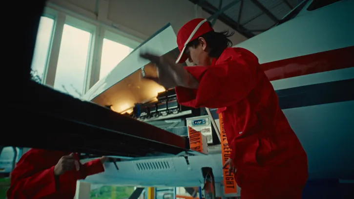 Two students working together to repair the wing of an aeroplane
