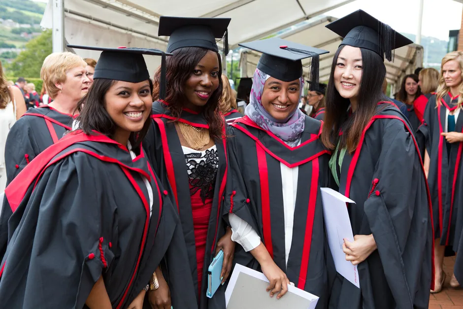 A group of students celebrating at graduation.