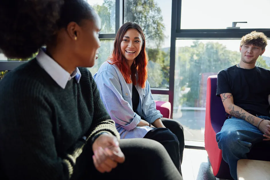 A group of students happily chatting on the sofas in Treforest Student's Union.