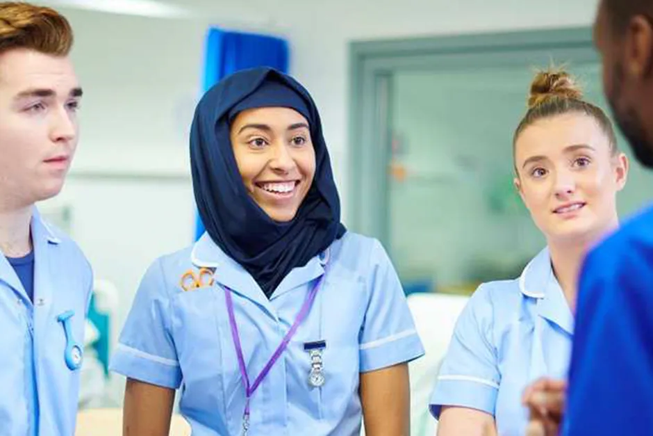 A group of nursing students happily conversing with each other