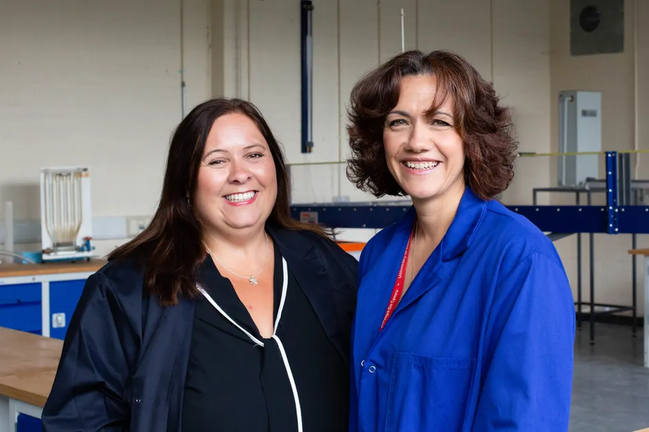 Two women in engineering smiling at the camera