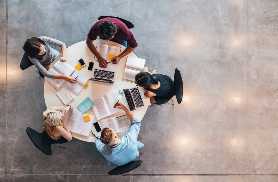 Top view of group of students sitting together at table