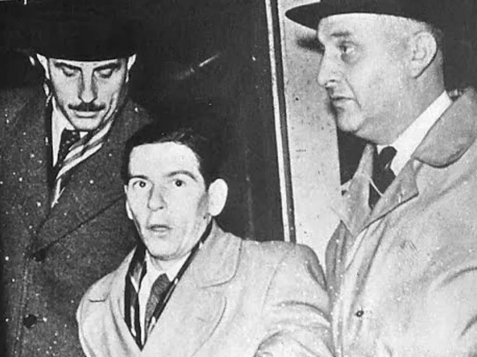 A black and white image of wrongly convicted Timothy Evans, surrounded by two men. Image credit to Wales Online