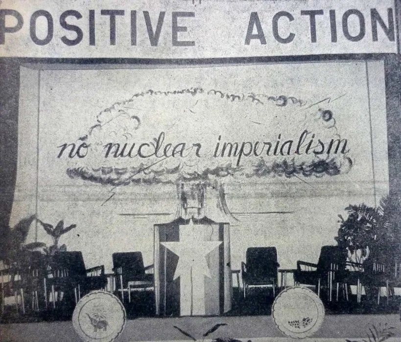A black and white illustration that shows a nuclear explosion and reads ''positive action'' ''no nuclear imperialism''
