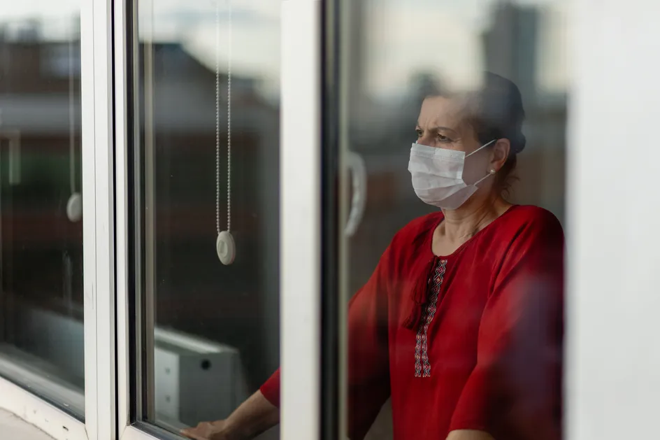 Lady wearing facemask in window