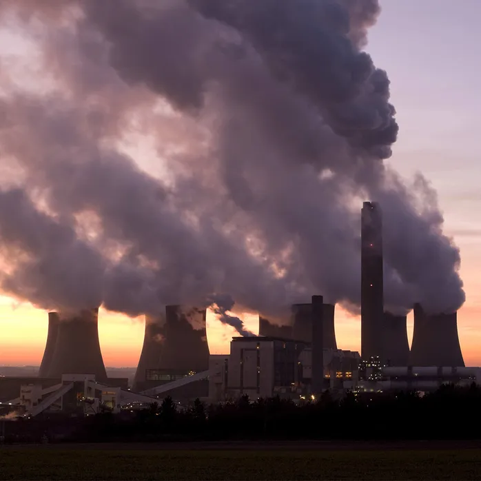 Coal power station with billowing steam coming out of the stacks