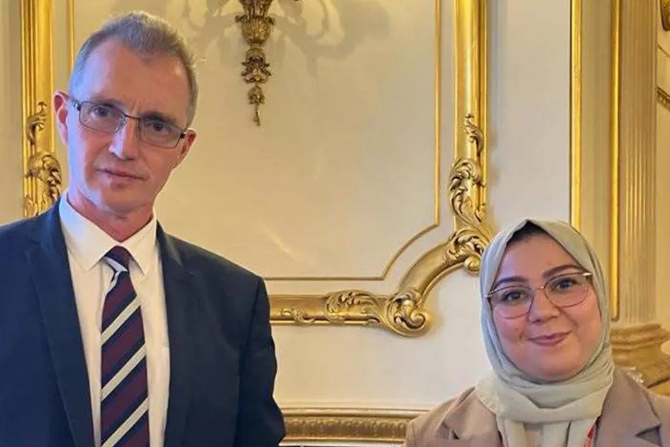 Welsh Secretary David Davies and Dr Mabrouka Abuhmida smiling at the camera at Lancaster House in London.
