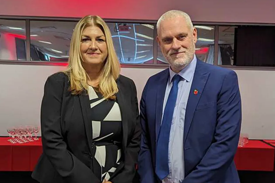 Dr Ben Calvert, Is-Ganghellor PDC, a Cathy Abraham, Prif Swyddog Gweithredol yn gwenu ar y camera yng Nghanolfan Gynadledda Trefforest