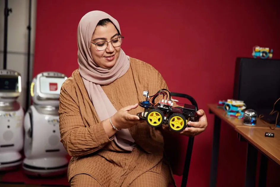 Dr Mabrouka Abuhmida looking at an AI-powered miniature car