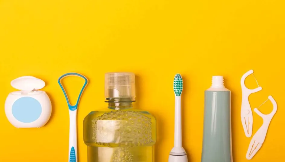 Dentistry equipment, such as a floss, mouthwash, toothbrush, toothpaste, in a line on a yellow background