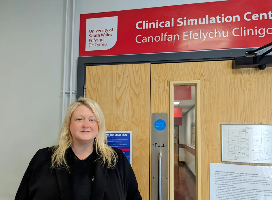 a person stands in front of a hospital door