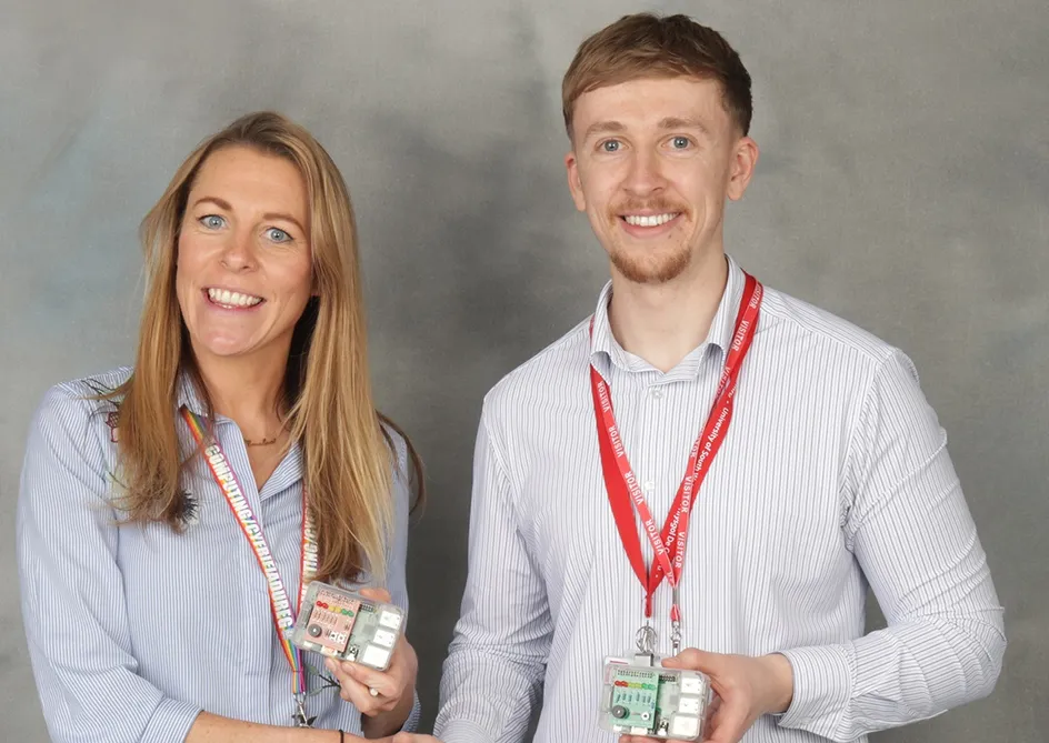 Joseph Griffiths handing over the Raspberry Pi machines to Emelie Cox, who is a computing teacher at Afon Tâf