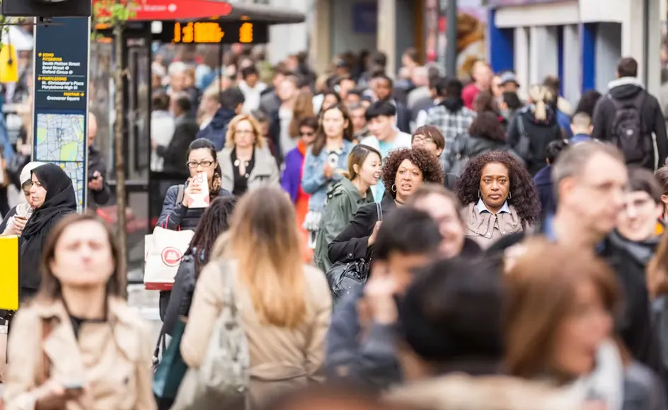 A crowd of people walking through London