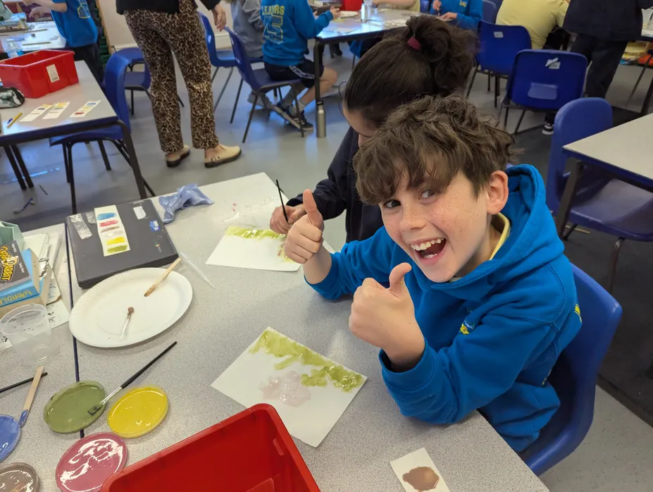 One of the pupils looking very happy while taking part in an outreach session