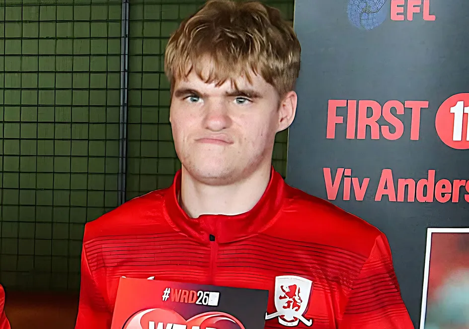 Elliot is wearing a red football kit