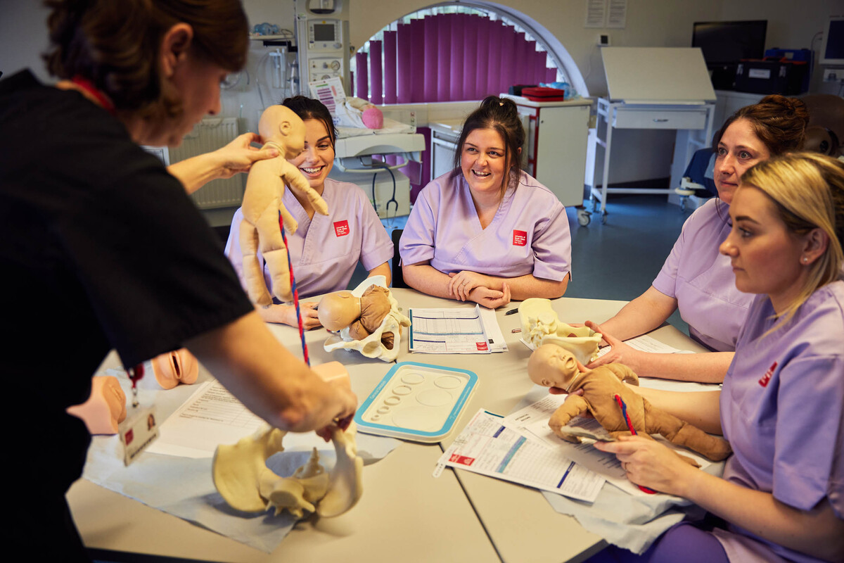 Midwifery students gathered together for a birthing demostration.