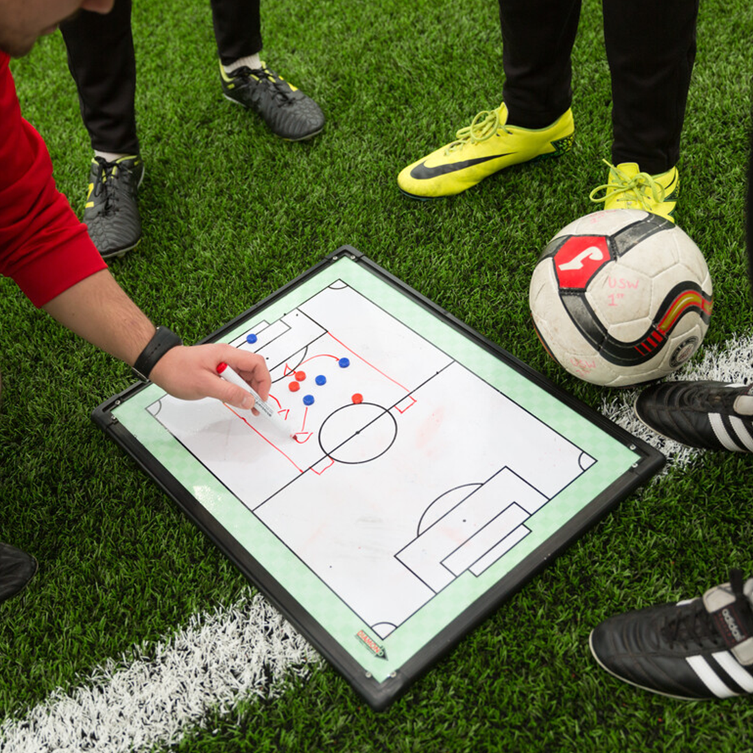 A close up of a whiteboard showing football strategy.