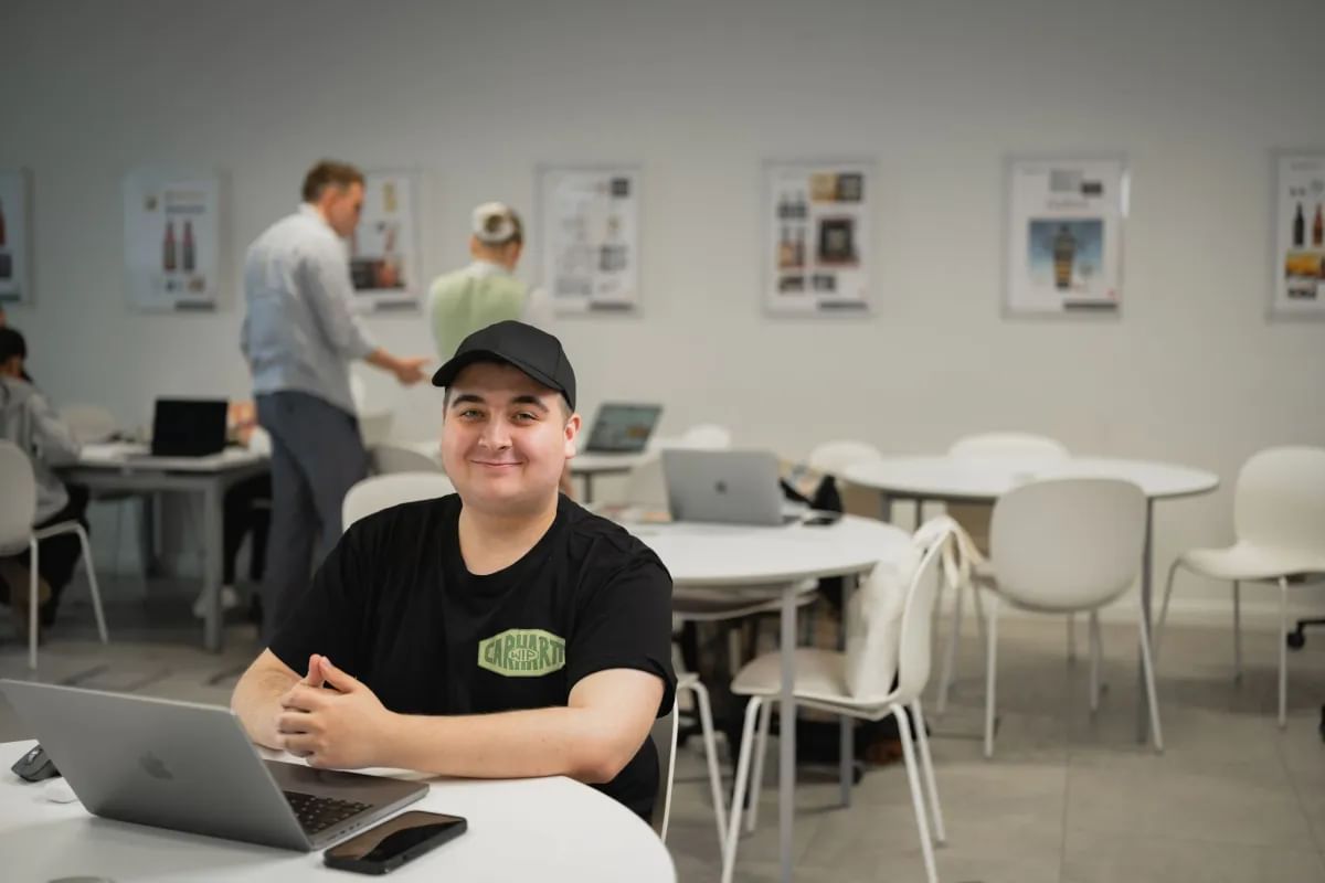 Advertising student, Ivan, sat at a desk with a laptop