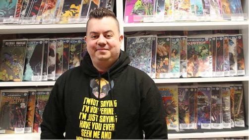 Graduate and business owner Shane poses for a photo in his shop