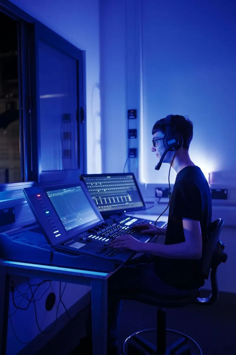 Louis wearing headphones focusing on his work at a computer