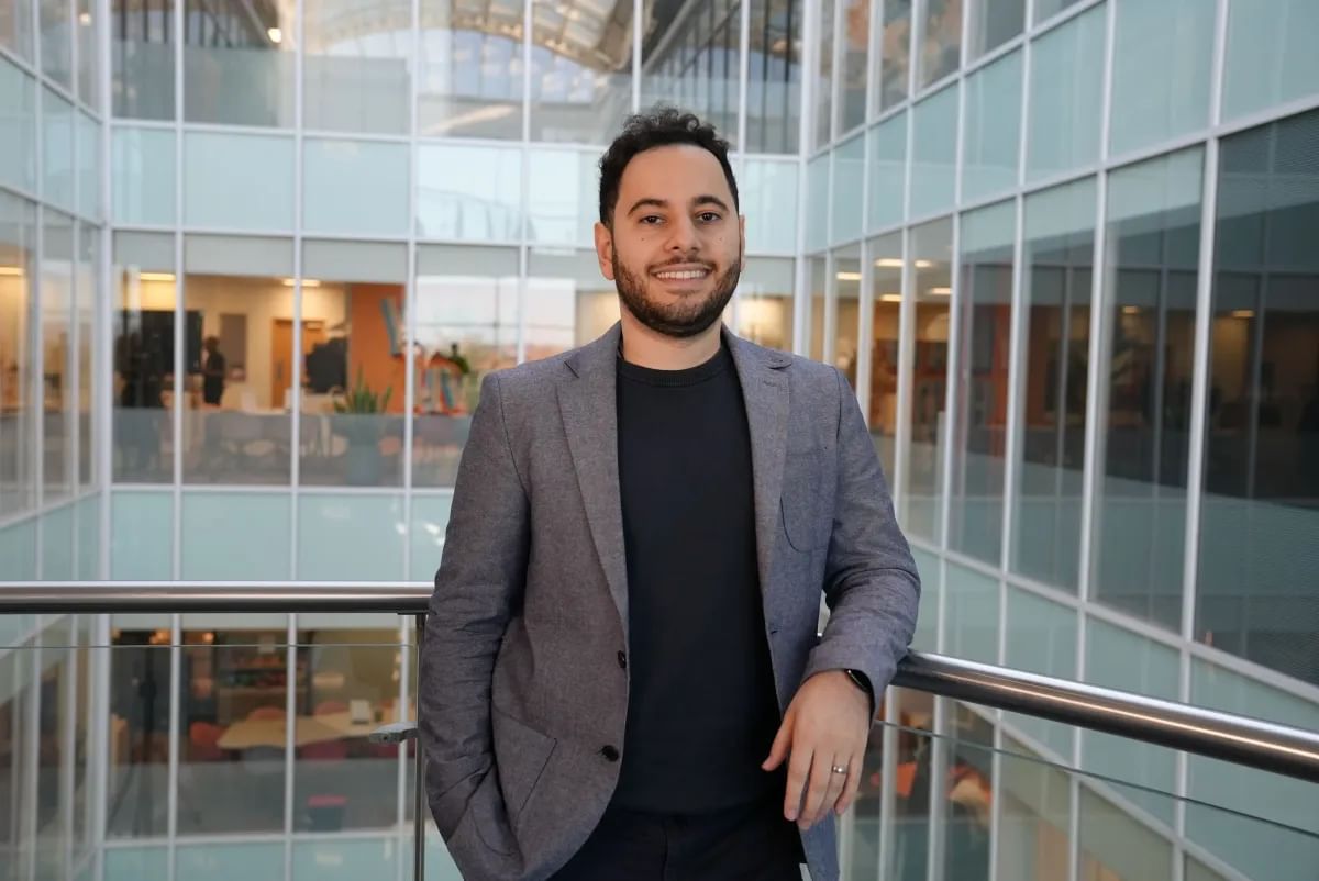 Computing graduate, Hamed, poses for a photo in his workplace