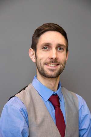 A photo of Thomas Hill smiling at the camera