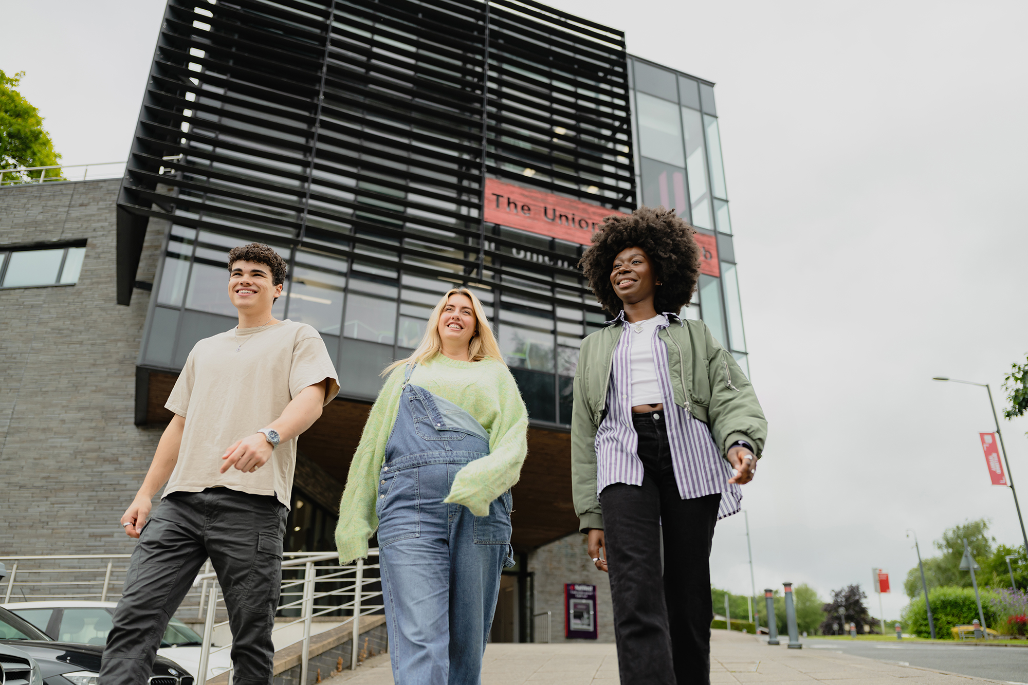 three students walking from the Treforest students union building