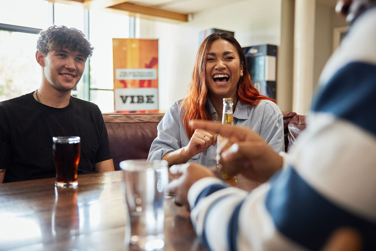 A group of students sat laughing over drinks at Treforest Student's Union