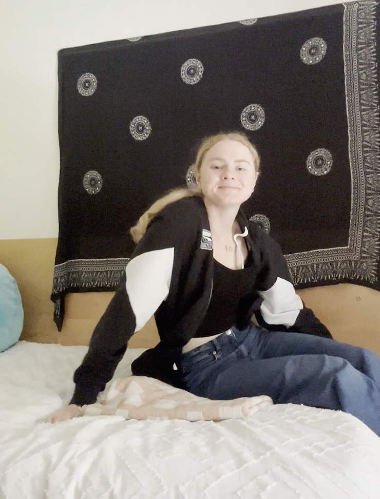 A student, sitting on her bed in the USW accommodation.