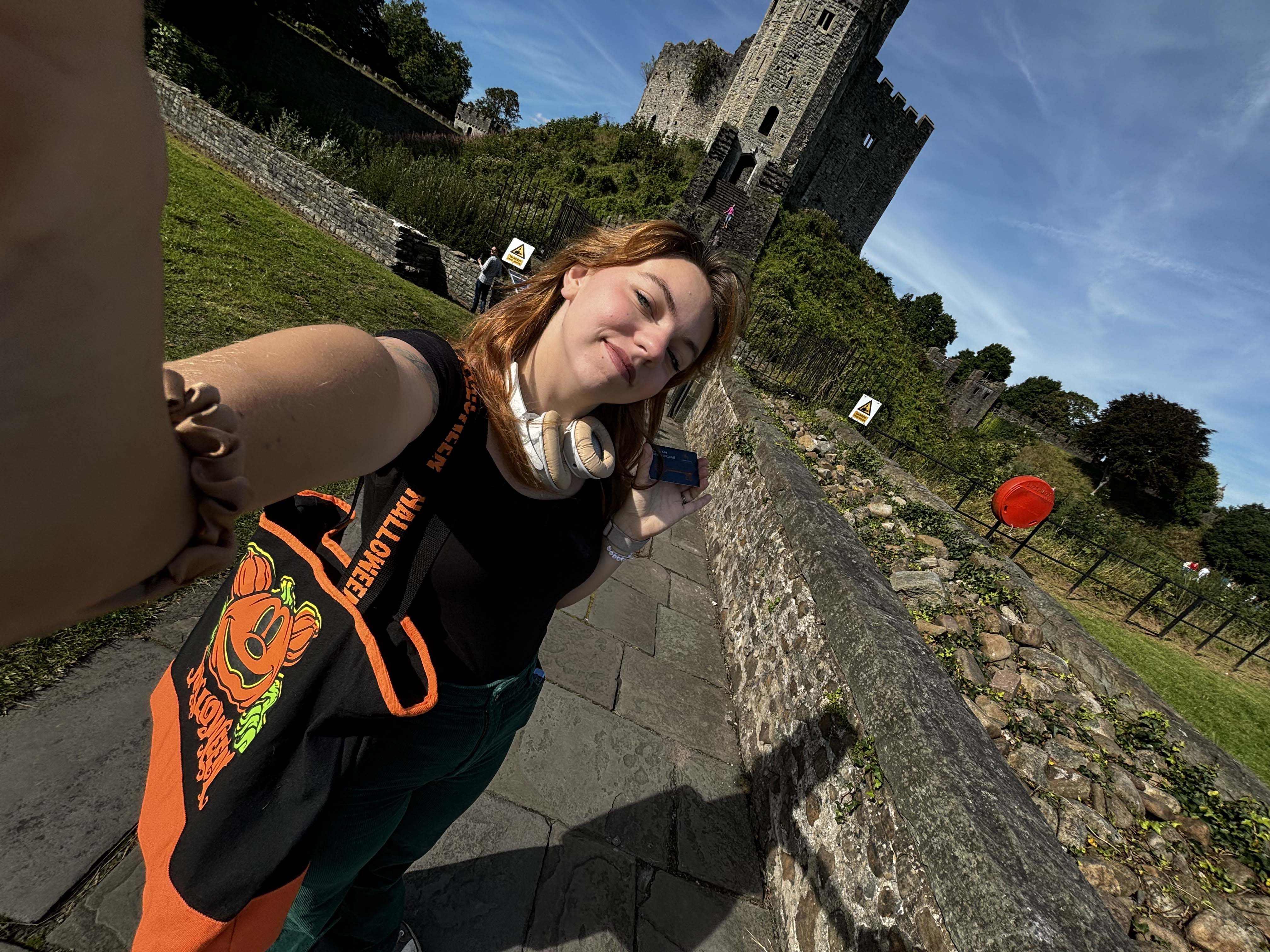 Student, Ashleigh, taking a selfie in front of Cardiff Castle.