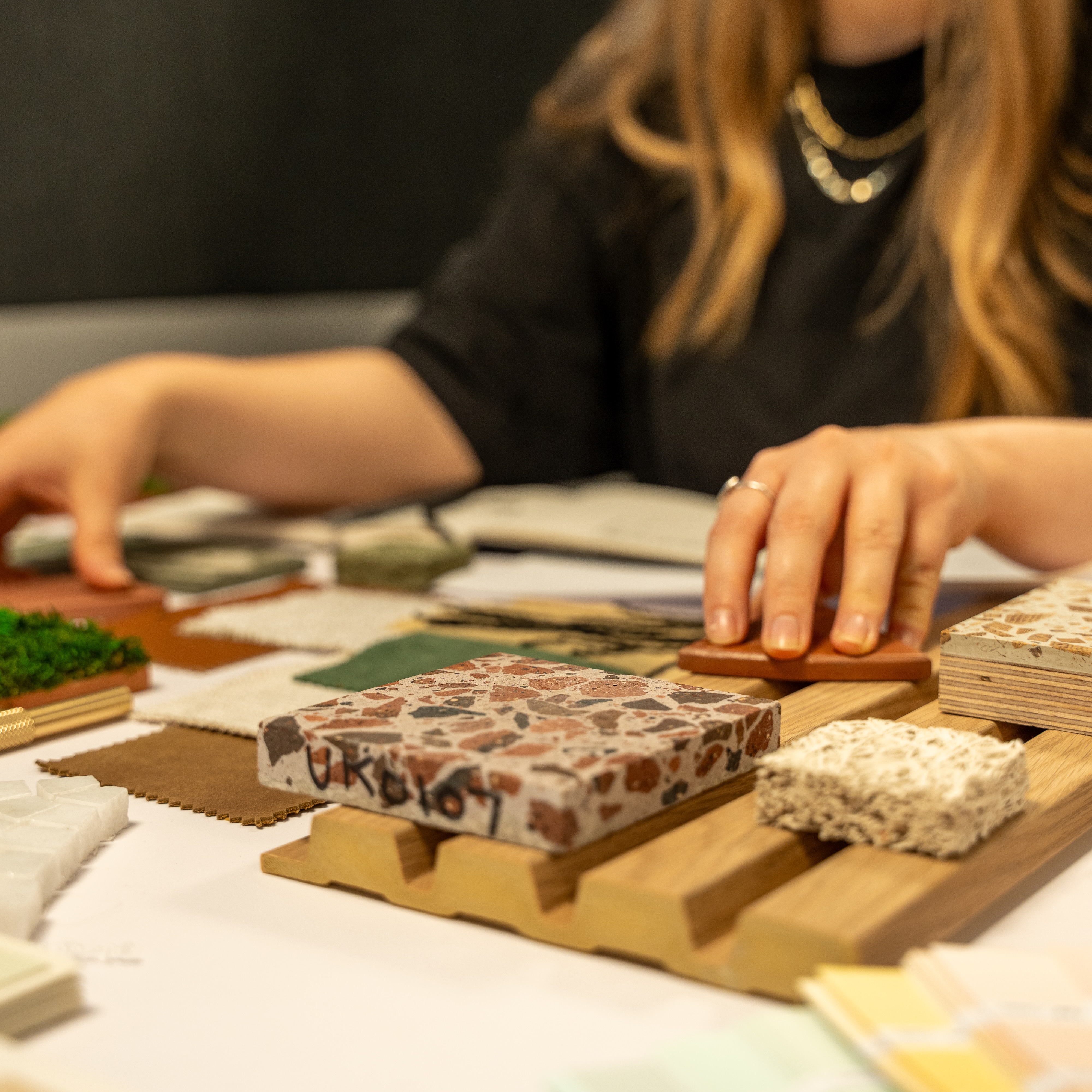 A student organising different patterns, textures and materials on a work desk
