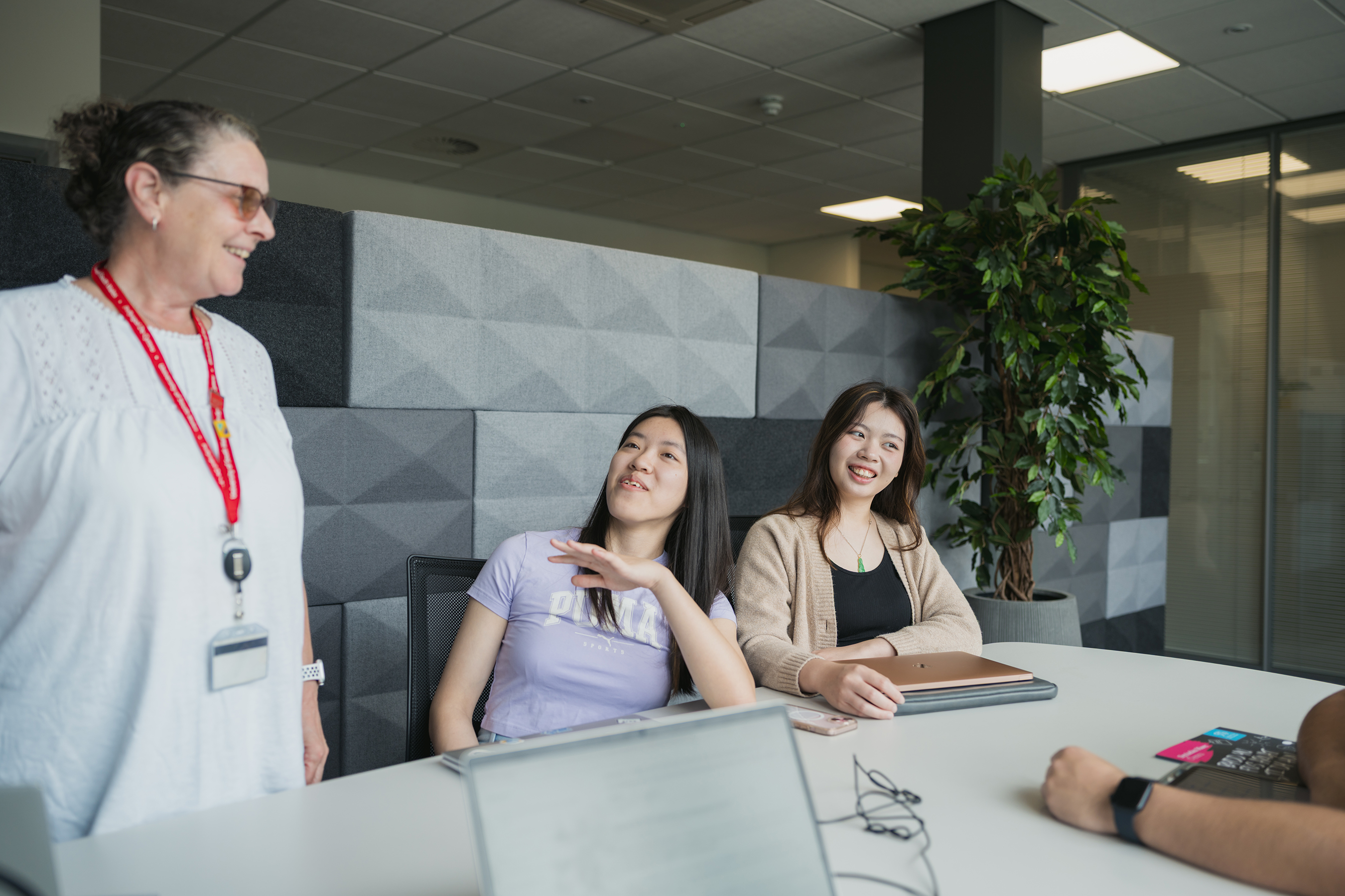 two students sat at a desk talking to a USW careers consultant