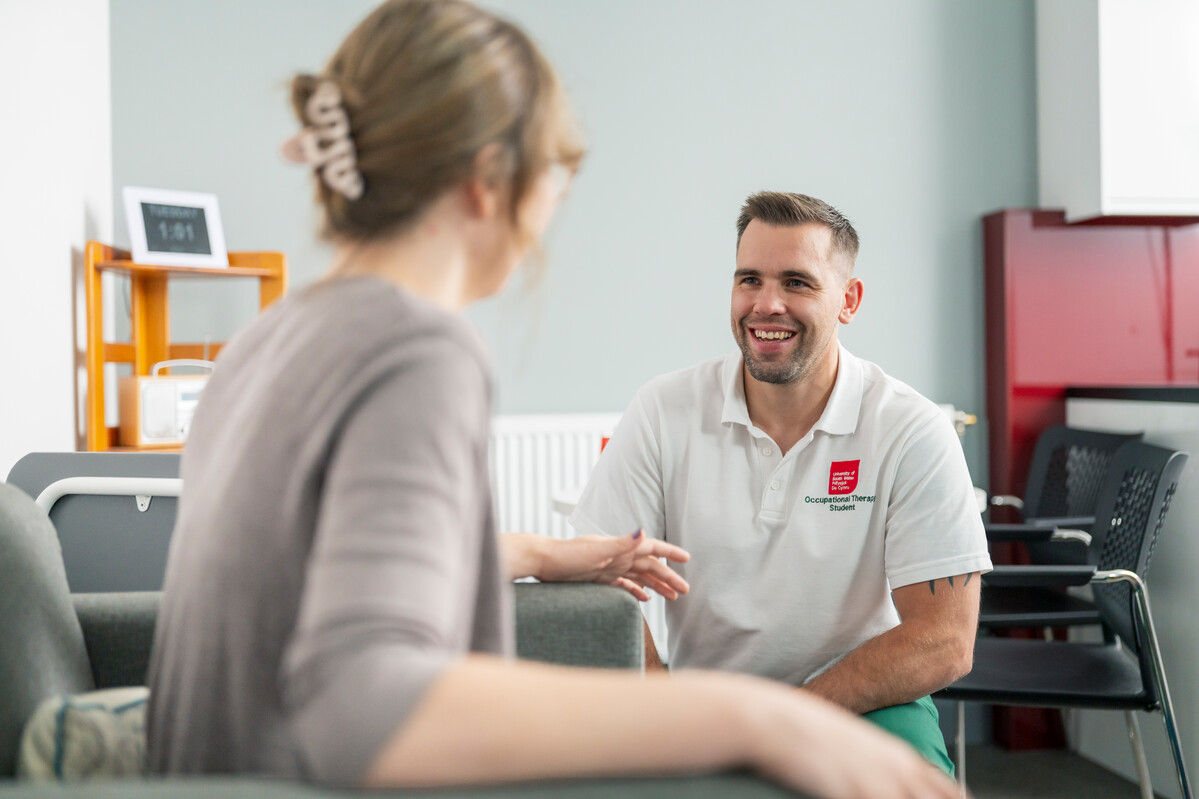 Occupational therapy student attending to a patient in the community flat at the clinical simulation centre