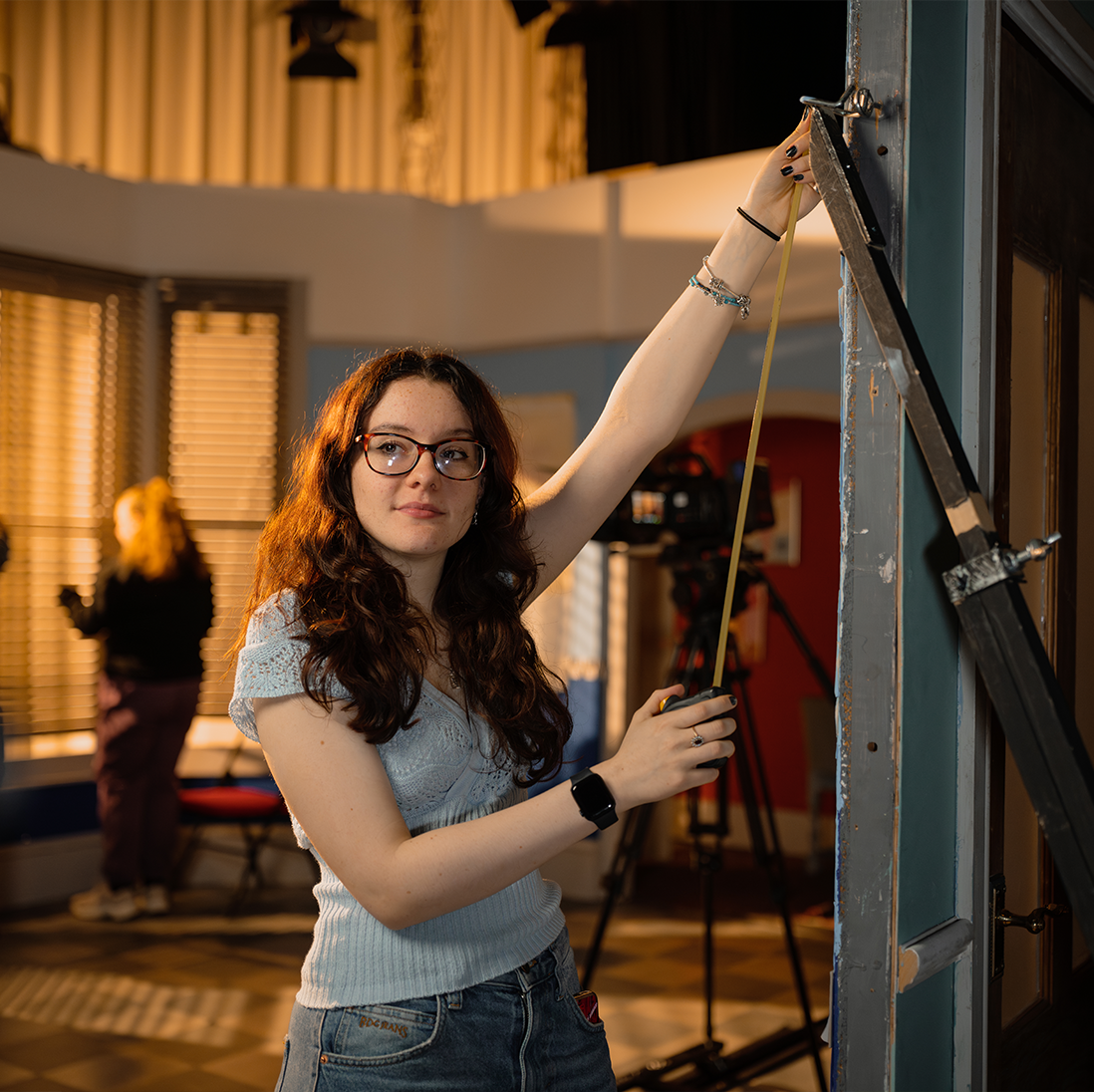 A TV and Film Set Design student measuring props for a set.