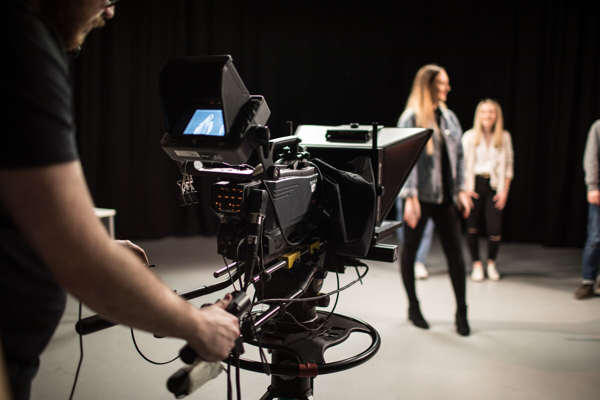 Recording camera being used to film students in a studio