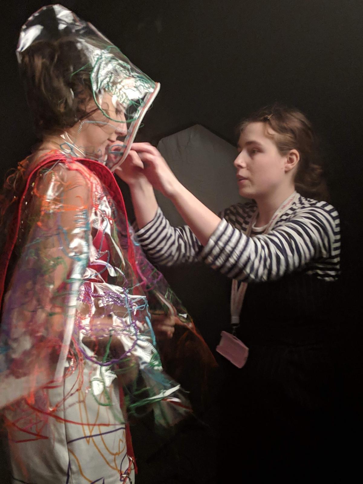 Fashion student, Paige, adjusts a models outfit during her time as an intern with Givenchy