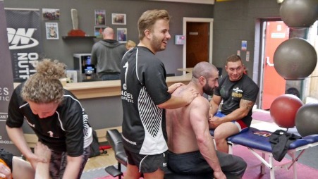 Chiropractic student treating a patient in a training room